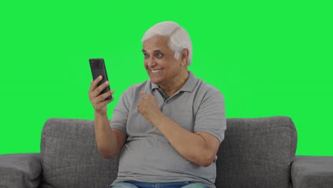 Happy-Indian-old-man-talking-on-video-call-Green-screen