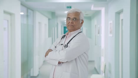 Portrait-of-Confident-Indian-senior-doctor-standing-crossed-hands