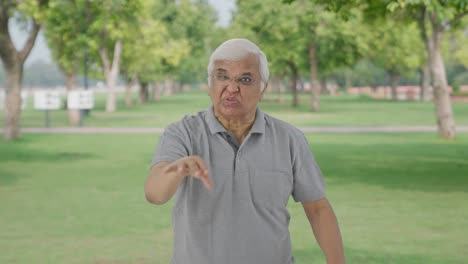 Angry-Indian-old-man-stopping-someone-in-park