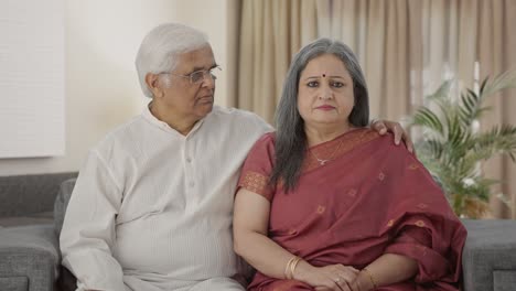 Serious-Old-Indian-couple-staring-at-the-camera