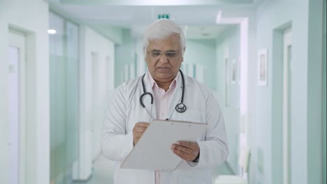 Médico-Senior-Indio-Escribiendo-Receta