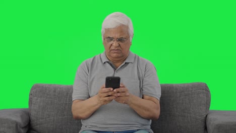 Angry-Indian-old-man-chatting-on-phone-Green-screen