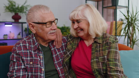 Happy-senior-family-couple-grandparents-man-woman-looking-at-camera-demonstrating-keys-from-new-flat