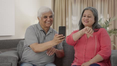 Happy-Old-Indian-husband-clicking-pictures-of-his-wife