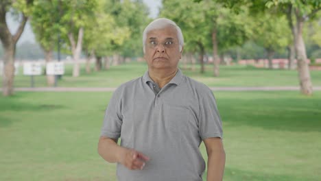 Angry-Indian-old-man-shouting-to-someone-in-park