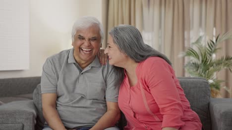 Indian-old-wife-telling-a-secret-to-her-husband-in-ear