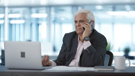 Indian-senior-manager-talking-on-mobile-phone