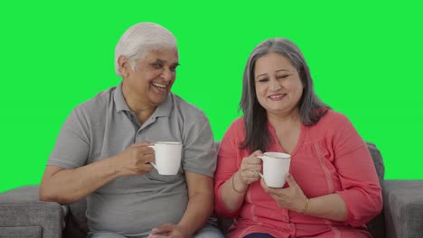 Happy-Indian-old-couple-drinking-tea-and-smiling-Green-screen