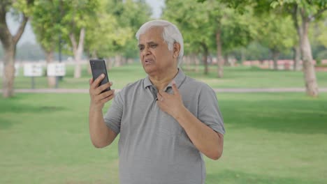 Indian-old-man-talking-on-video-call-in-park