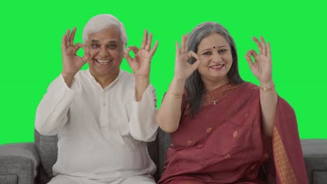 Happy-Old-Indian-couple-showing-okay-sign-Green-screen