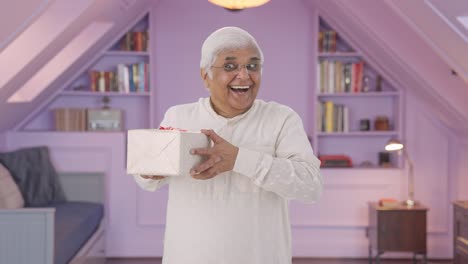 Happy-Indian-old-man-receiving-a-gift