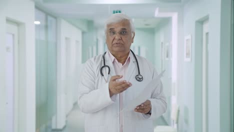 Indian-senior-doctor-explaining-health-reports-to-the-patient