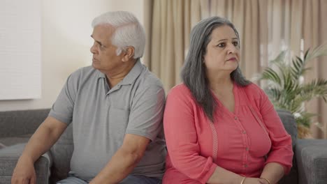 Angry-Indian-old-couple-sitting-back-to-back