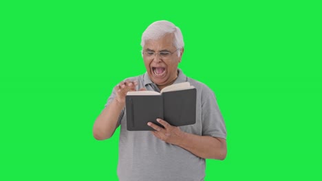 Sleepy-Indian-old-man-reading-a-book-Green-screen