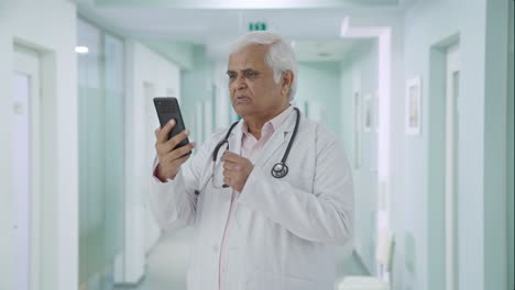 Indian-senior-doctor-consulting-patient-over-video-call