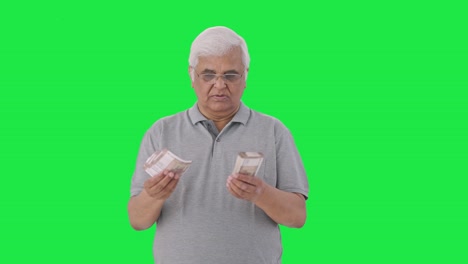 Indian-old-man-counting-money-Green-screen