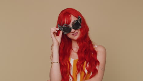 Seductive-stylish-red-hair-girl-in-tank-top-wearing-sunglasses,-charming-smile-looking-at-camera