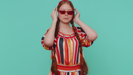 Cheerful-redhead-girl-listening-music-via-headphones-and-dancing-disco-fooling-around-having-fun