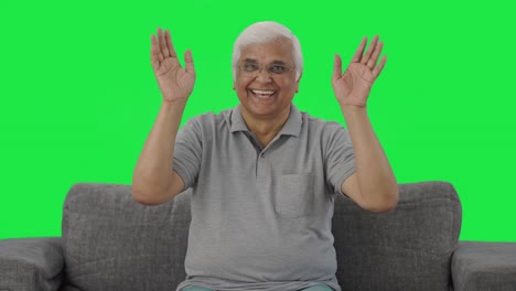 Happy-Indian-old-man-waving-and-saying-Hello-Green-screen