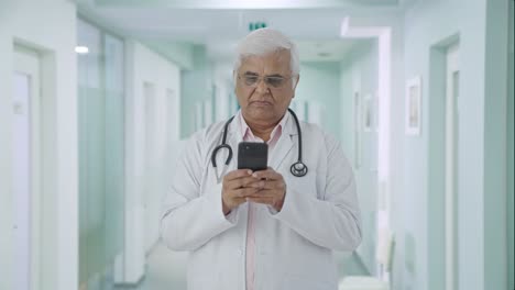 Indian-senior-doctor-chatting-with-someone