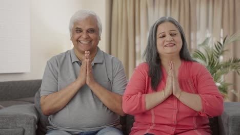 Happy-Indian-old-couple-doing-Namaste