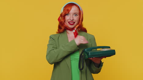 Cheerful-red-hair-girl-secretary-talking-on-wired-vintage-telephone-of-80s,-say-hey-you-call-me-back