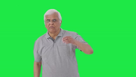 Curious-Indian-old-man-finding-something-Green-screen