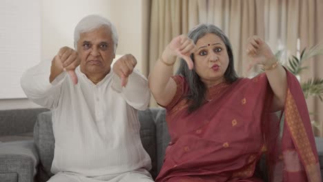 Angry-Old-Indian-couple-showing-thumbs-down