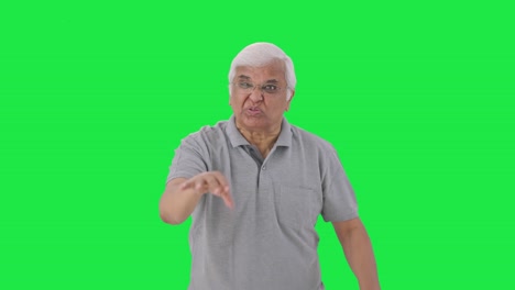 Angry-Indian-old-man-stopping-someone-Green-screen