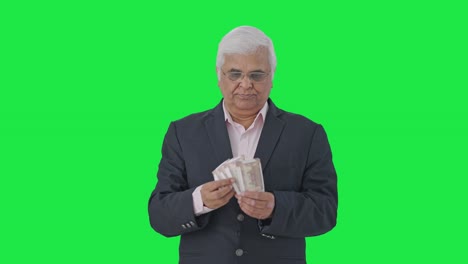 Indian-senior-manager-counting-money-Green-screen