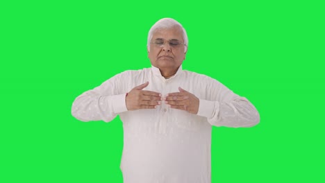 Indian-old-man-doing-breathe-in-breathe-out-exercise-Green-screen