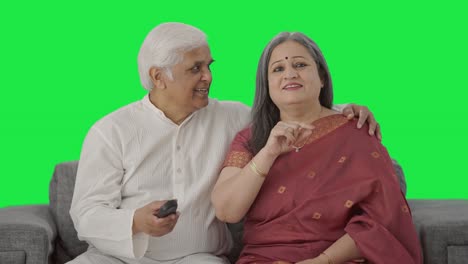 Happy-Old-Indian-couple-watching-TV-Green-screen