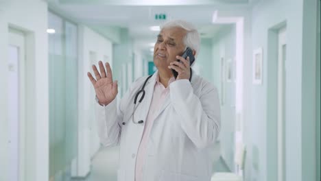 Indian-senior-talking-to-someone-on-call