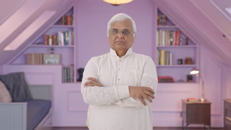 Confident-Indian-old-man-standing-crossed-hands