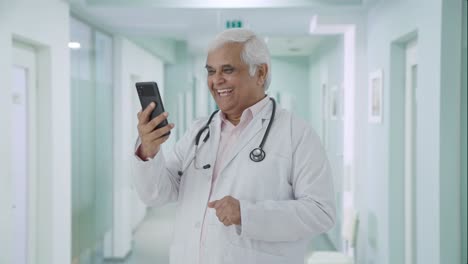 Happy-Indian-senior-doctor-consulting-patient-over-video-call