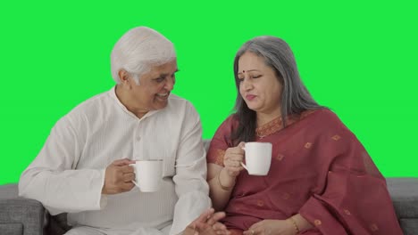 Happy-Old-Indian-couple-drinking-tea-and-enjoying-Green-screen