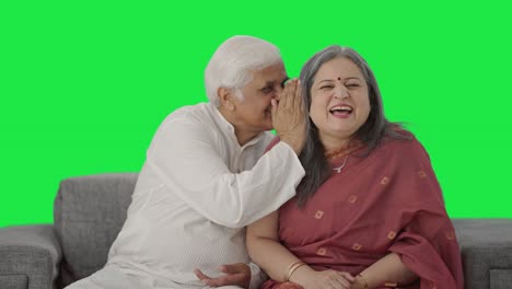 Happy-Old-Indian-husband-telling-a-secret-to-his-wife-Green-screen