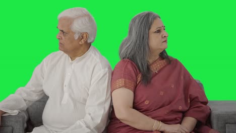 Angry-Old-Indian-couple-sitting-back-to-back-Green-screen