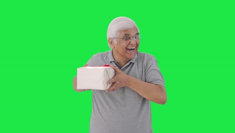 Happy-Indian-old-man-receiving-a-gift-Green-screen