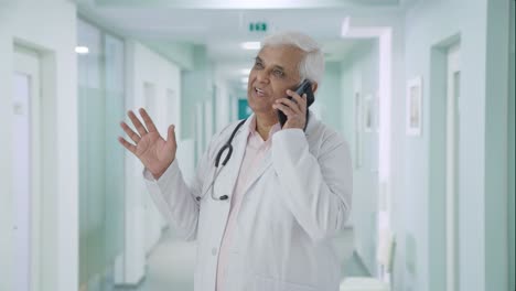 Happy-Indian-senior-talking-to-someone-on-call