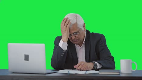 Disappointed-senior-Indian-businessman-slapping-his-head-Green-screen