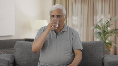 Sick-Indian-old-man-taking-medicine