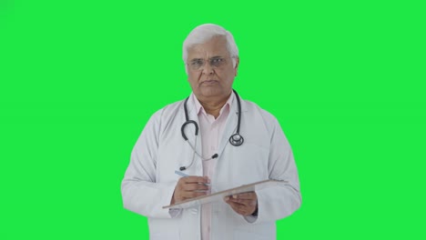 Indian-senior-doctor-listening-to-the-patient-Green-screen