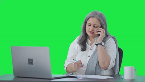 Angry-Indian-senior-female-manager-shouting-on-phone-Green-screen