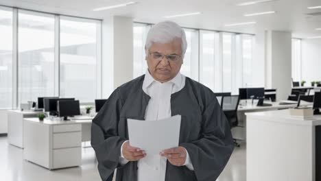 Frustrated-Indian-senior-lawyer-reading-court-case-papers