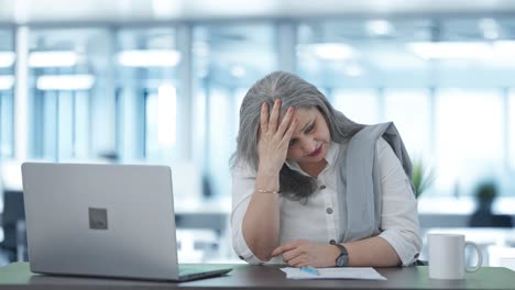 Tensed-Indian-senior-businesswoman-thinking-something