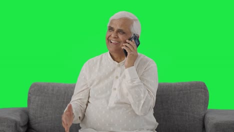 Happy-Indian-old-man-talking-on-phone-Green-screen