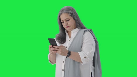 Indian-senior-businesswoman-chatting-on-phone-Green-screen