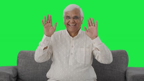 Happy-Indian-old-man-waving-hand-and-saying-hello-Green-screen