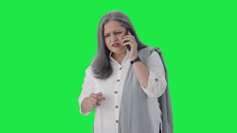 Angry-Indian-senior-businesswoman-shouting-on-call-Green-screen